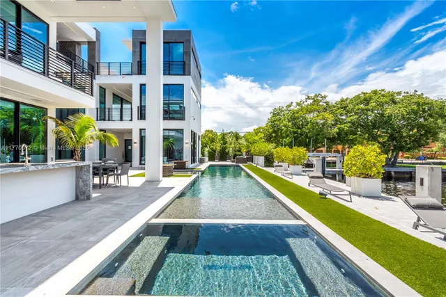 a living room with furniture a rug and a large window