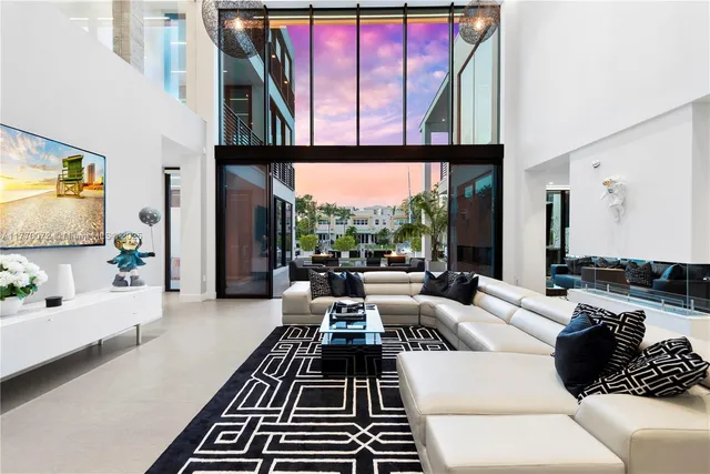 a living room with furniture and large windows