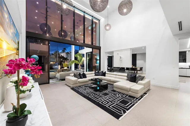 a living room with furniture and a floor to ceiling window