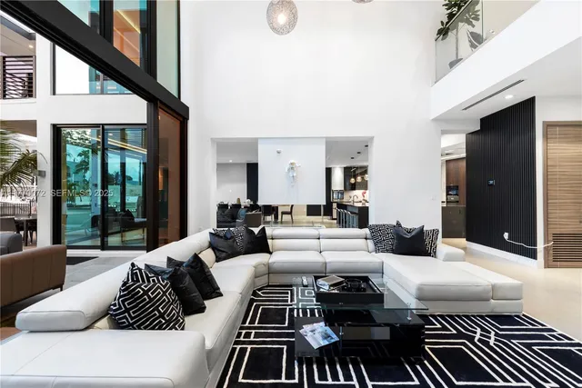 a living room with furniture and a floor to ceiling window