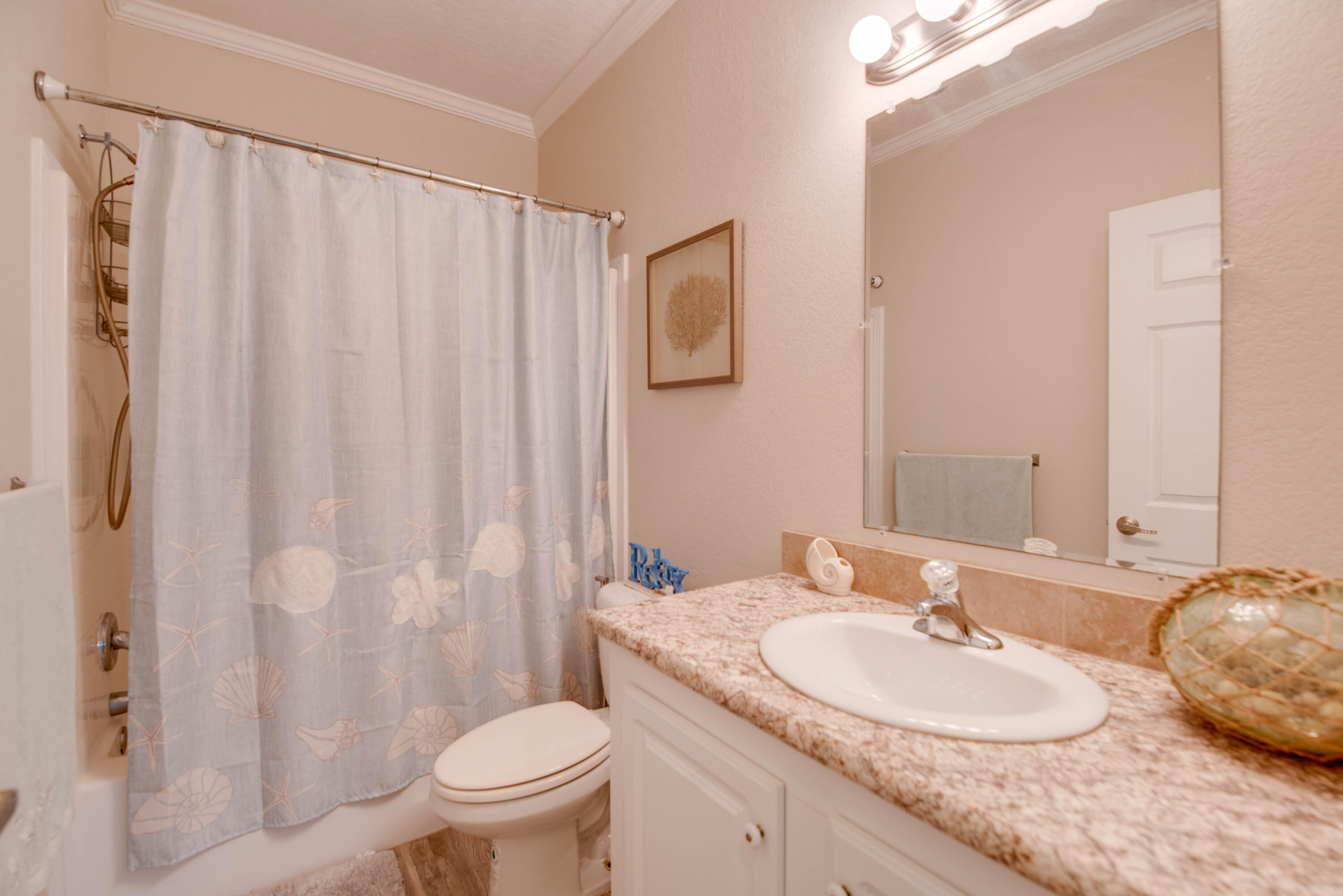 27373 Antigua Road Summerland Key, FL 33042 - Photo 17 of 31 a bathroom with a granite countertop sink toilet and a mirror