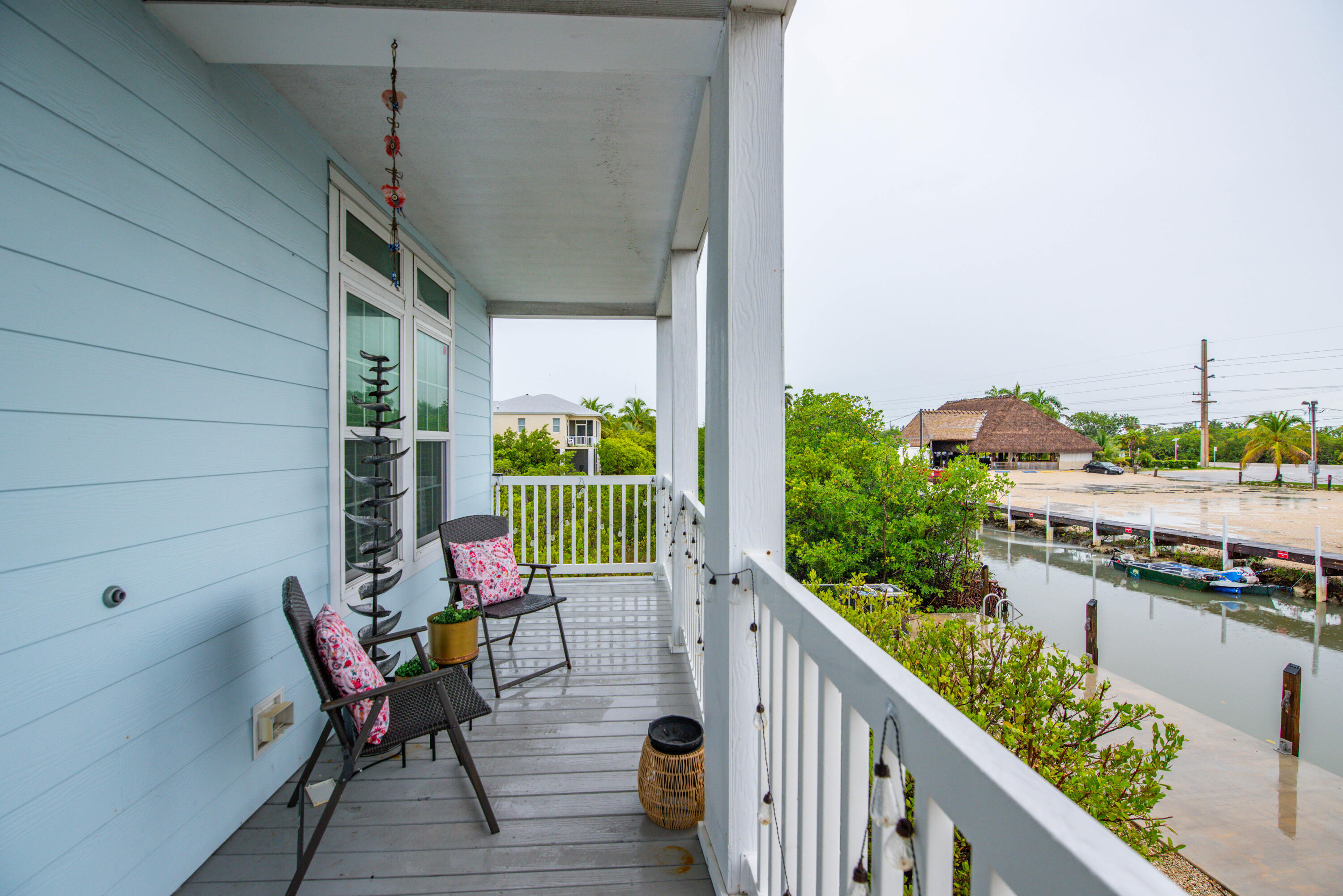 27373 Antigua Road Summerland Key, FL 33042 - Photo 19 of 31 a balcony with chairs and wooden floor