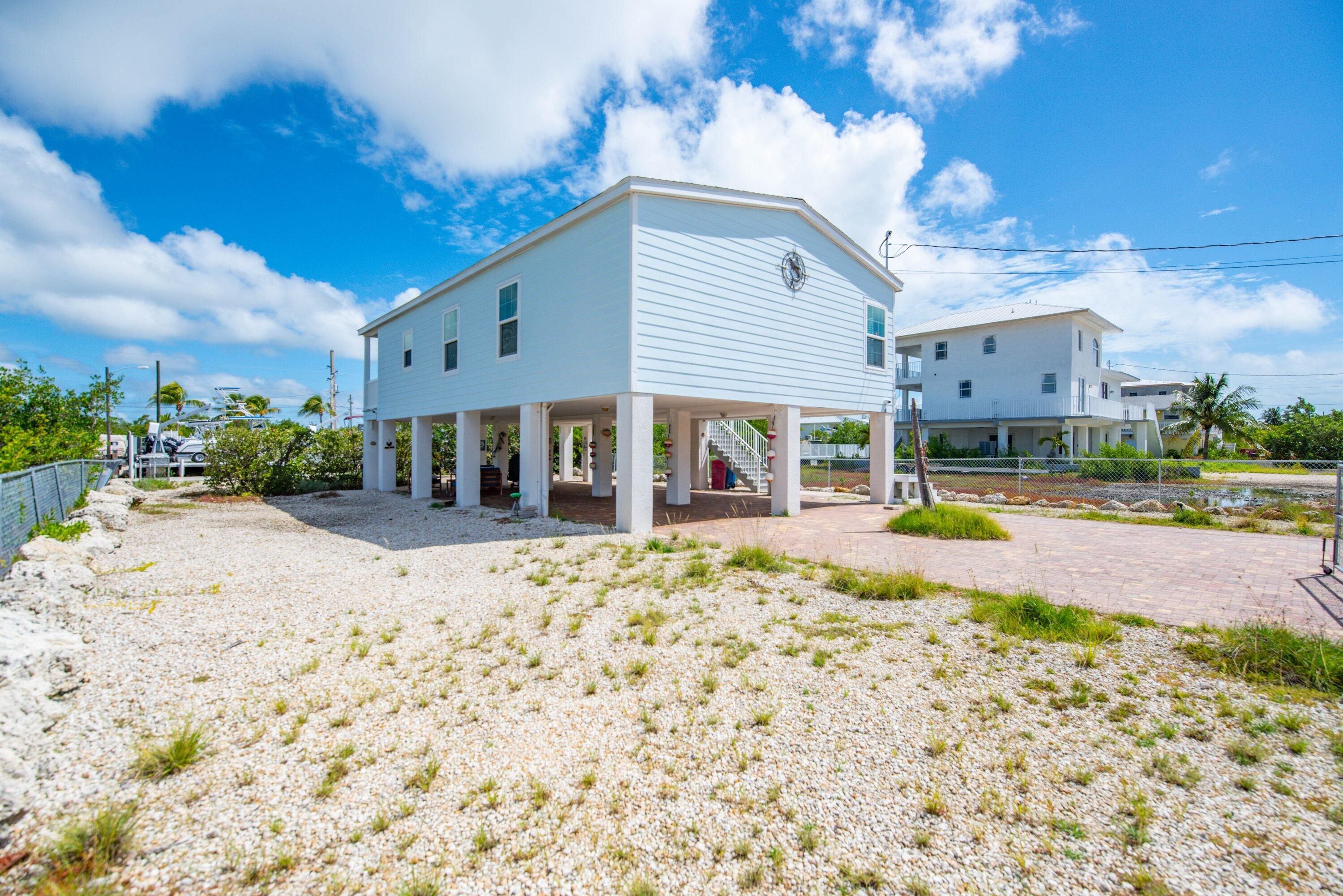 27373 Antigua Road Summerland Key, FL 33042 - Photo 22 of 31 a view of a house with backyard porch and patio
