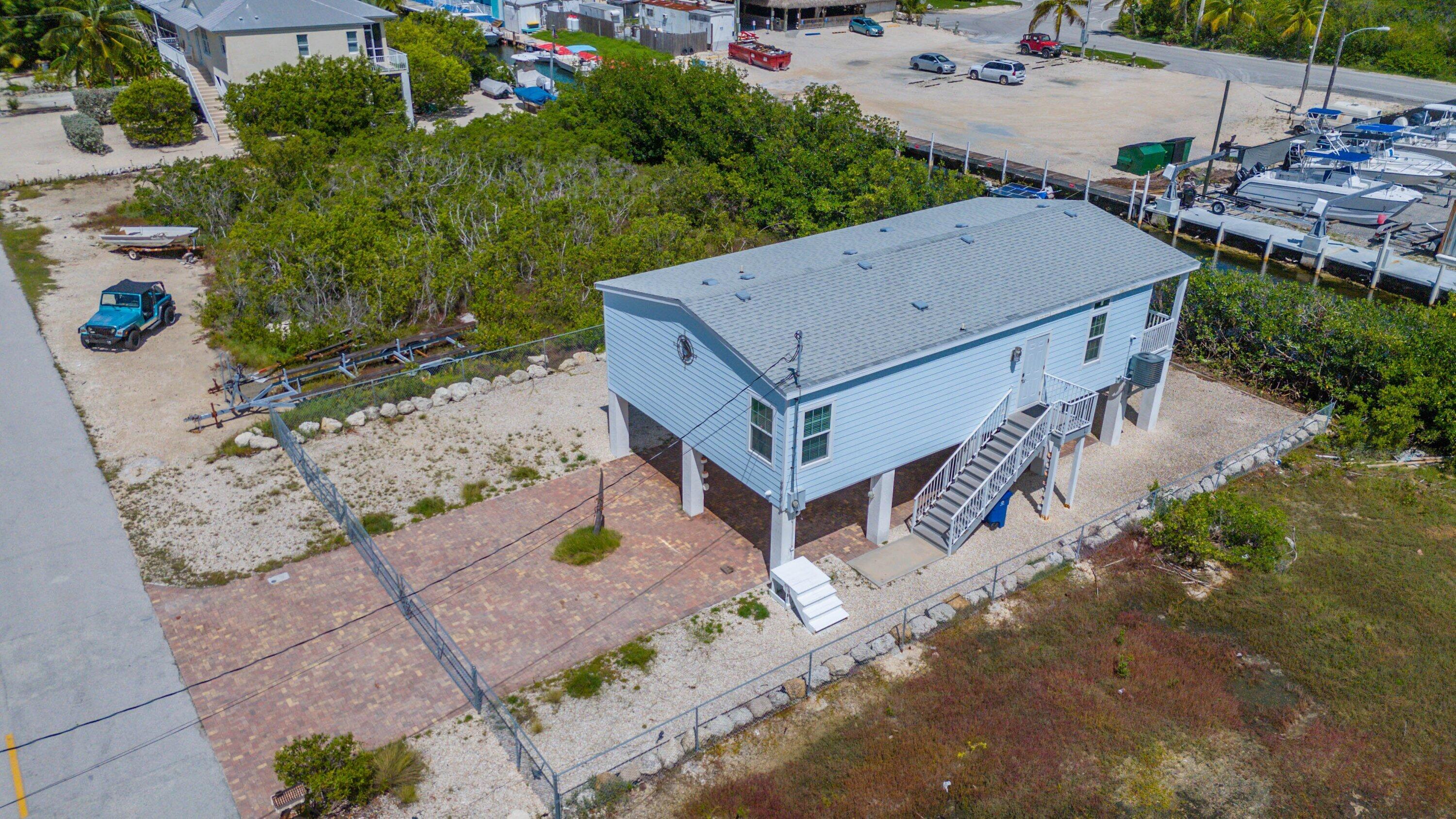 27373 Antigua Road Summerland Key, FL 33042 - Photo 29 of 31 an aerial view of a house with a yard and large trees