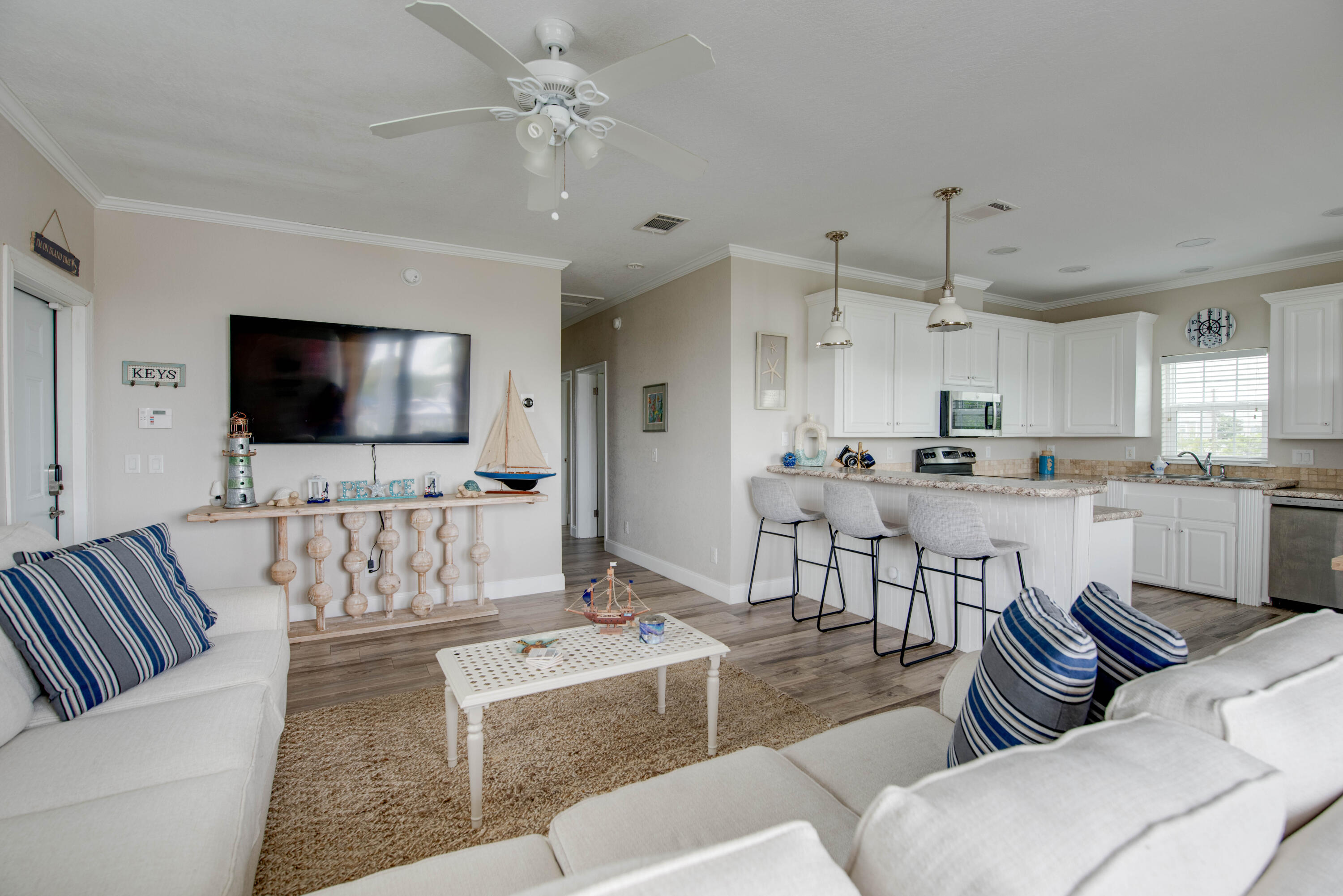 27373 Antigua Road Summerland Key, FL 33042 - Photo 8 of 31 a living room with furniture kitchen view and a flat screen tv