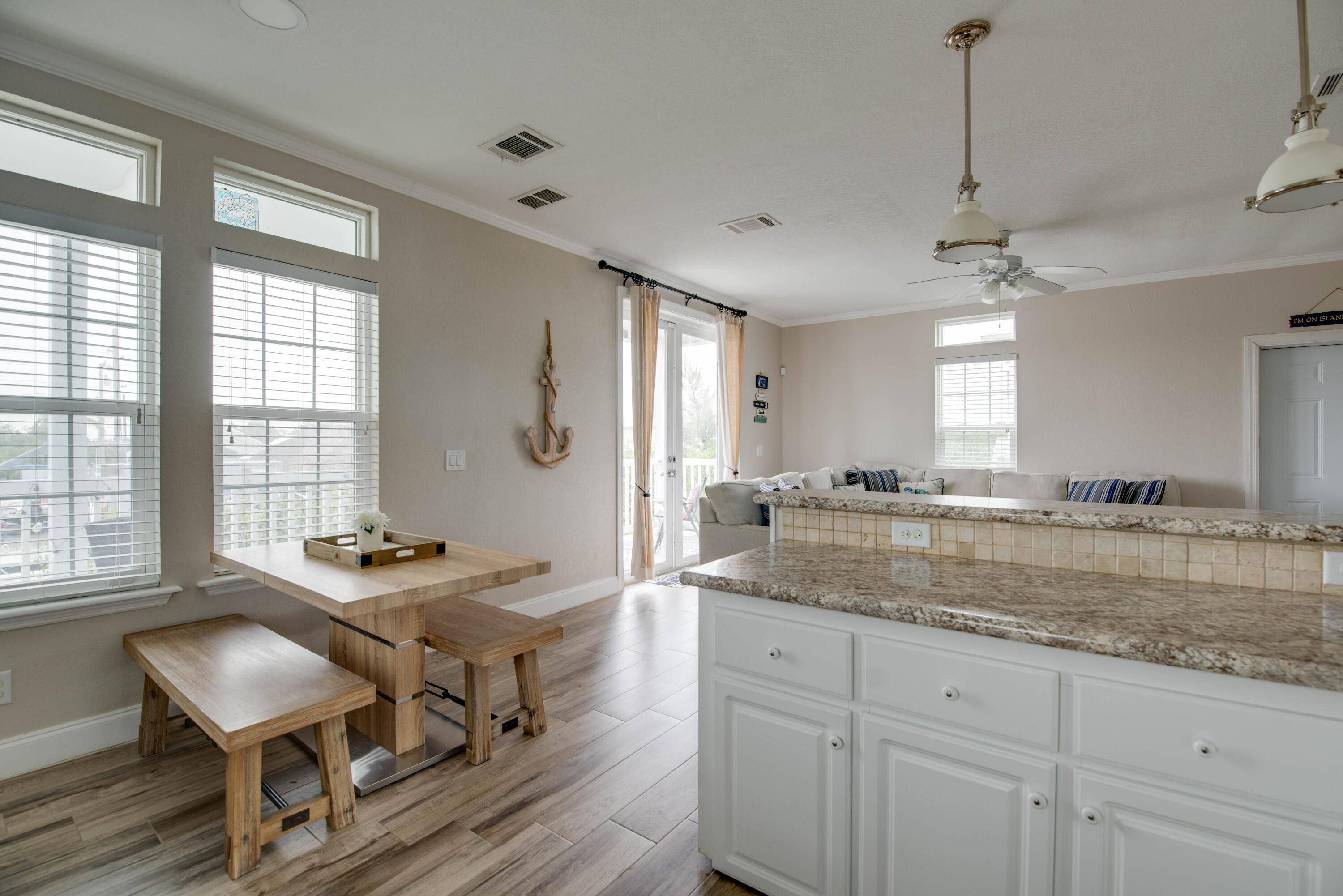 27373 Antigua Road Summerland Key, FL 33042 - Photo 10 of 31 a dining hall with stainless steel appliances granite countertop a stove a sink a dining table and chairs with wooden floor