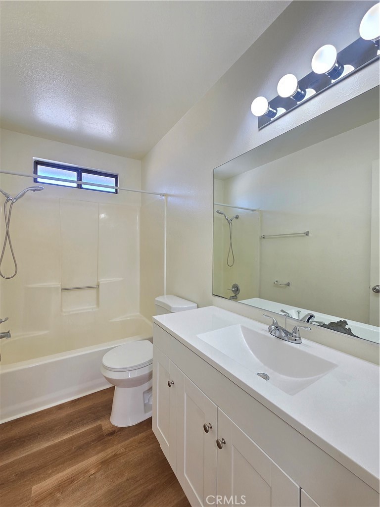 8318 Dogbane Avenue, Unit A California City, CA 93505 - Photo 12 of 12 a bathroom with a granite countertop sink a toilet and shower