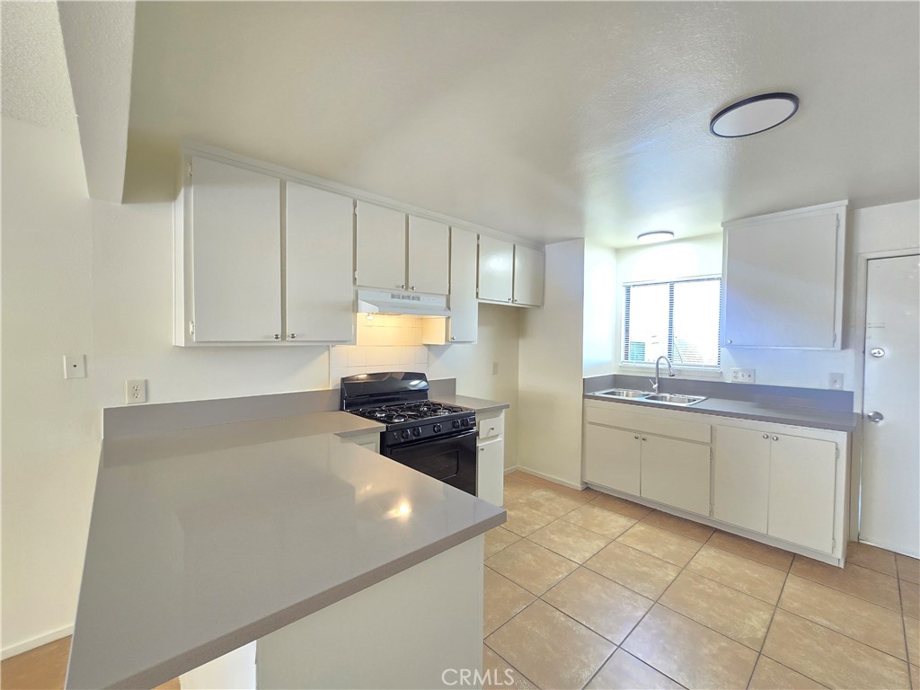 8318 Dogbane Avenue, Unit A California City, CA 93505 - Photo 4 of 12 a kitchen with cabinets and appliances