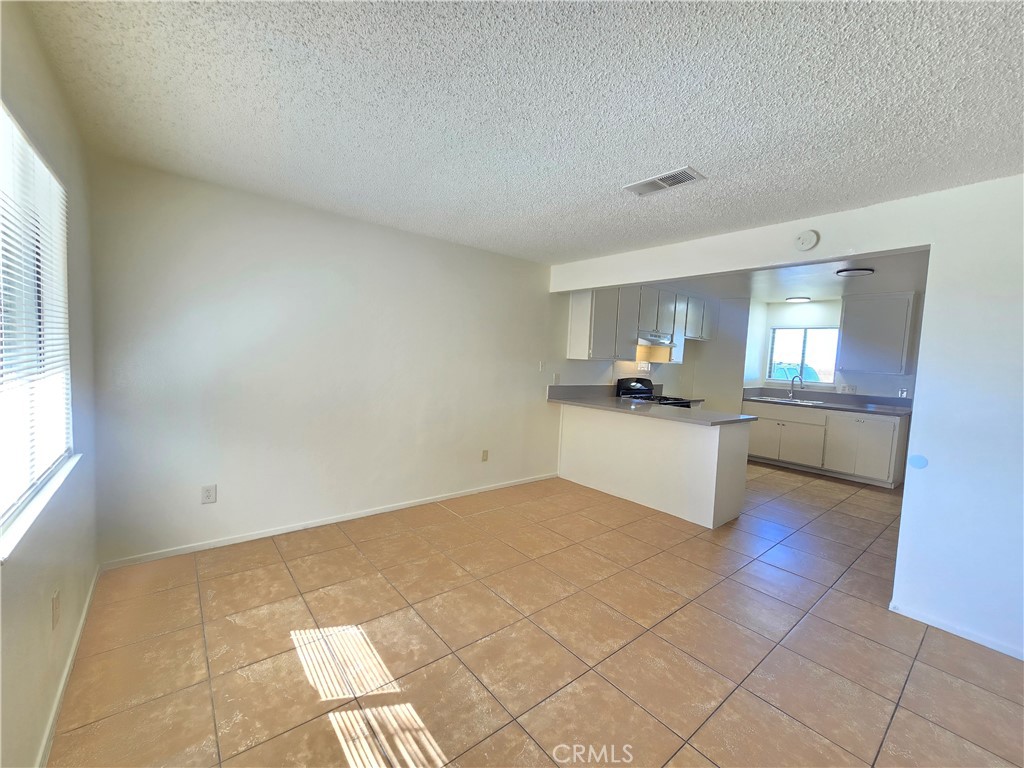 8318 Dogbane Avenue, Unit A California City, CA 93505 - Photo 6 of 12 a view of a kitchen with granite countertop sink and cabinets