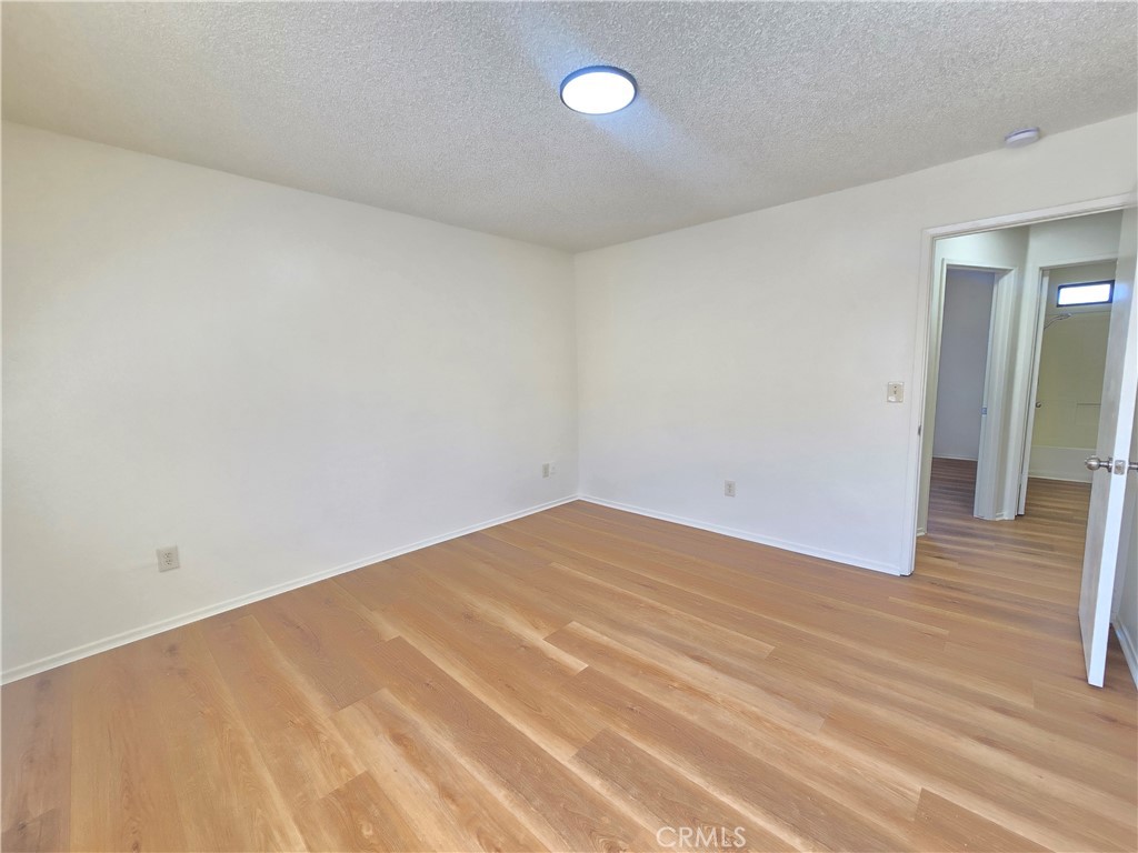 8318 Dogbane Avenue, Unit A California City, CA 93505 - Photo 8 of 12 a view of empty room with wooden floor