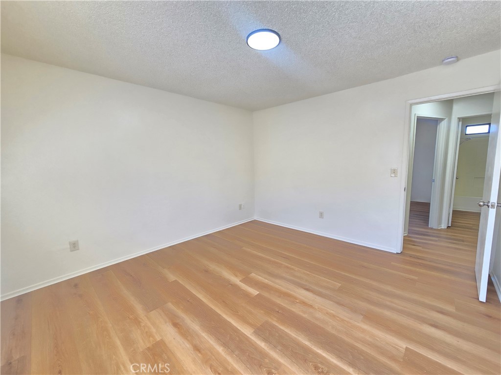 8318 Dogbane Avenue, Unit A California City, CA 93505 - Photo 9 of 12 a view of empty room with wooden floor