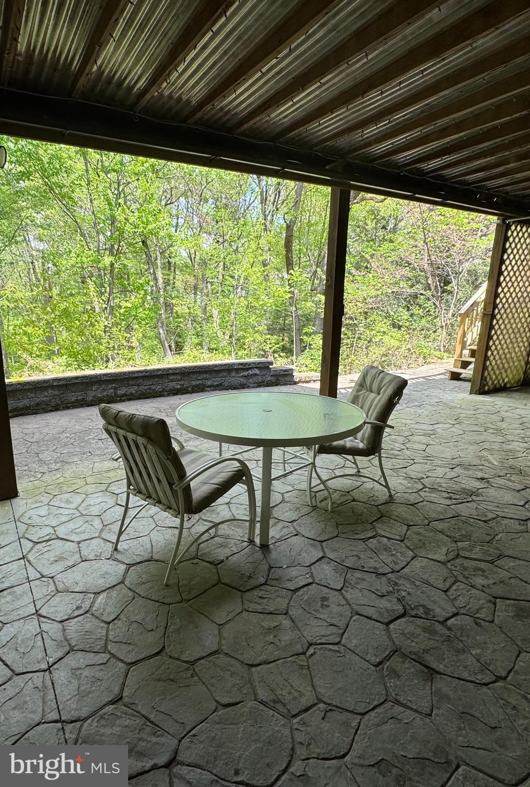 36 Wade Drive Lititz, PA 17543 - Photo 11 of 12 a roof deck with table and chairs and couches with wooden floor