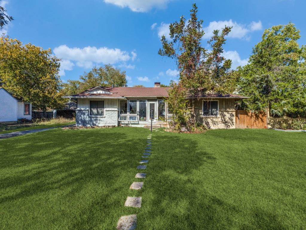 9127 San Fernando Way Dallas, TX 75218 - Photo 1 of 12 a front view of a house with a garden