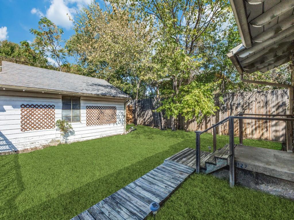 9127 San Fernando Way Dallas, TX 75218 - Photo 11 of 12 a front view of a house with a yard