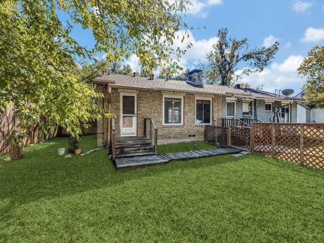 a view of a house with a yard and a garden
