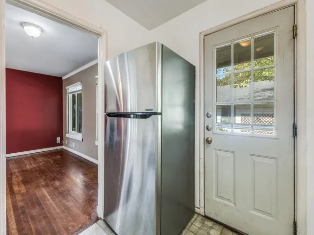 an empty room with wooden floor and a window