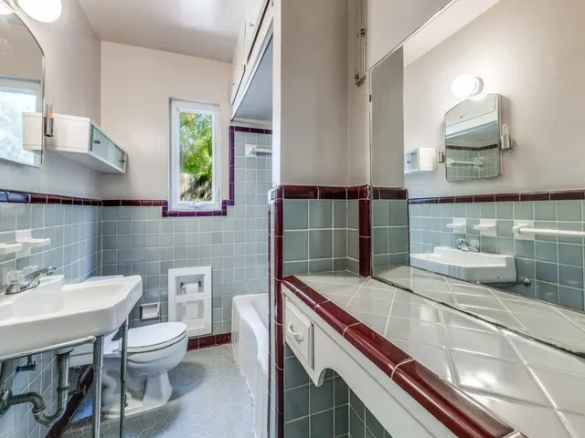 a bathroom with a sink a toilet and mirror
