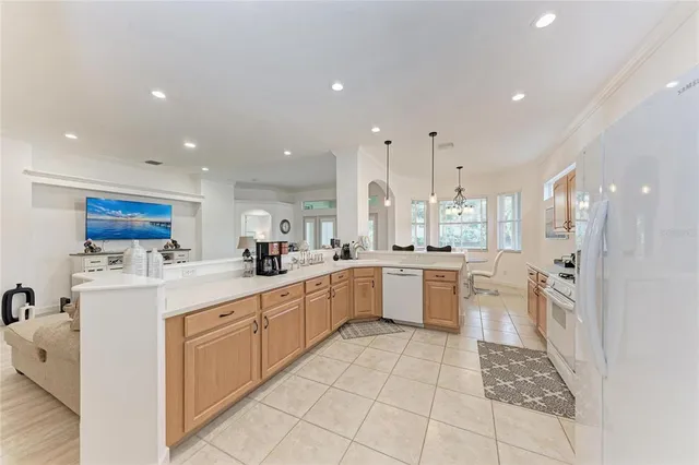 a large kitchen with stainless steel appliances kitchen island granite countertop a sink and cabinets