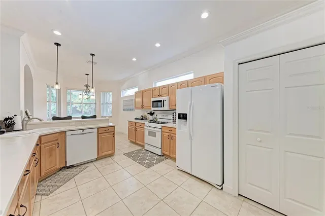 a kitchen with white cabinets and white appliances