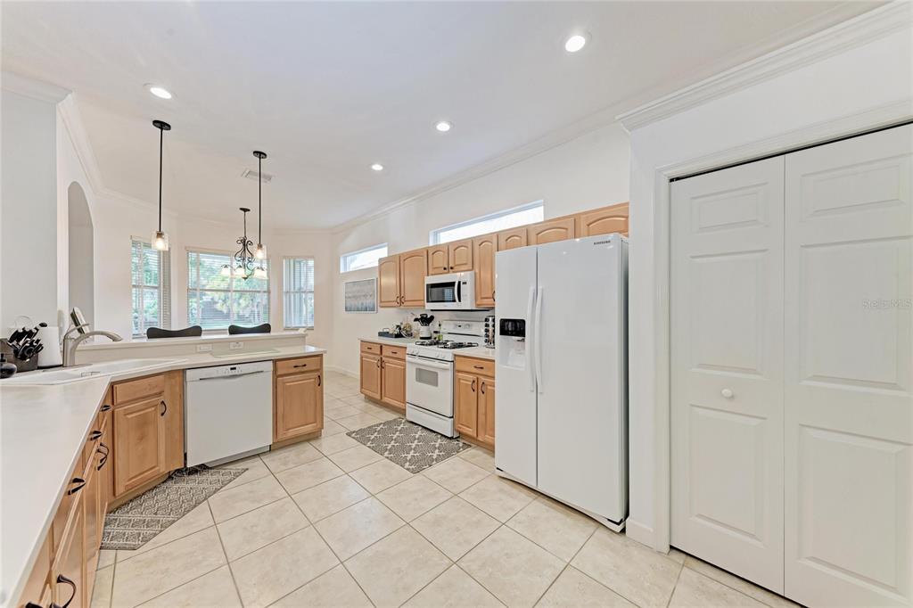 7128 Rue De Palisades, Unit 22 Sarasota, FL 34238 - Photo 13 of 41 a kitchen with white cabinets and white appliances