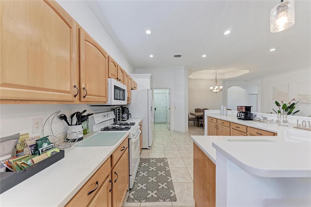 7128 Rue De Palisades, Unit 22 Sarasota, FL 34238 - Photo 15 of 41 a kitchen with stainless steel appliances granite countertop a sink stove and cabinets