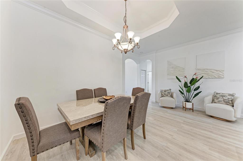 7128 Rue De Palisades, Unit 22 Sarasota, FL 34238 - Photo 18 of 41 a view of a dining room with furniture and wooden floor