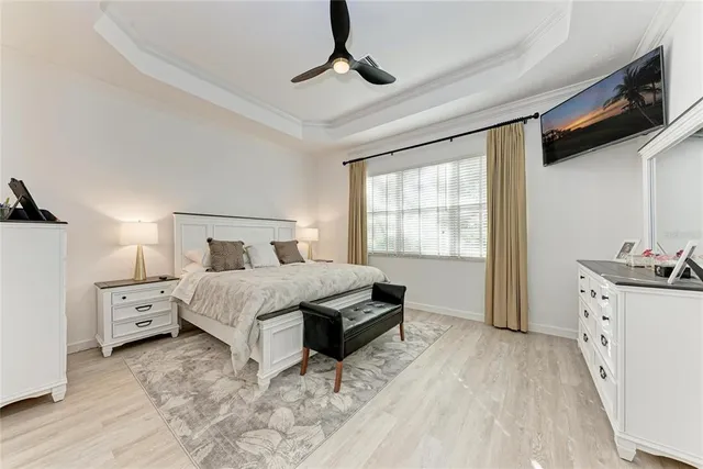 a bedroom with a bed and a chandelier