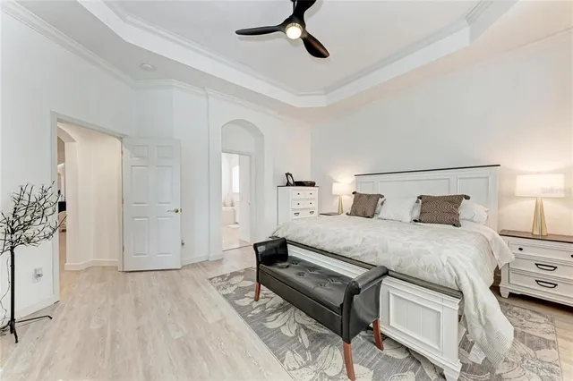 a bedroom with a bed and a chandelier