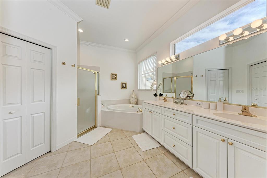 7128 Rue De Palisades, Unit 22 Sarasota, FL 34238 - Photo 23 of 41 a spacious bathroom with a granite countertop sink mirror and a