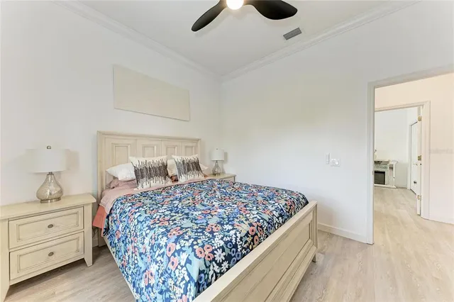 a bedroom with a large bed and a chandelier