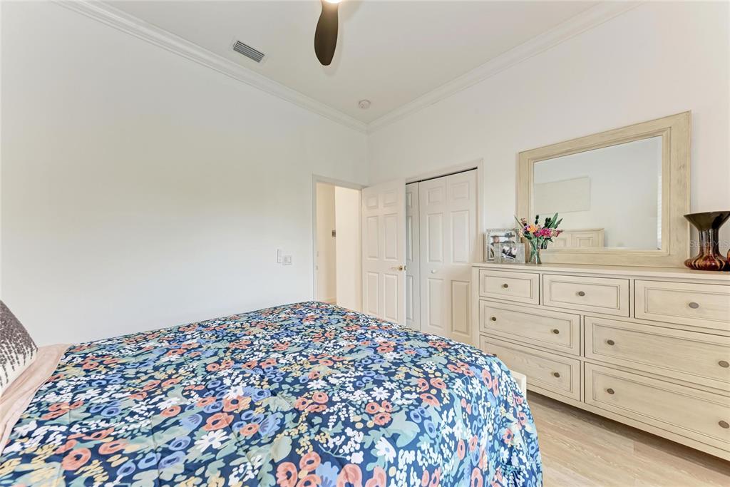 7128 Rue De Palisades, Unit 22 Sarasota, FL 34238 - Photo 26 of 41 a bedroom with a large bed and a dresser