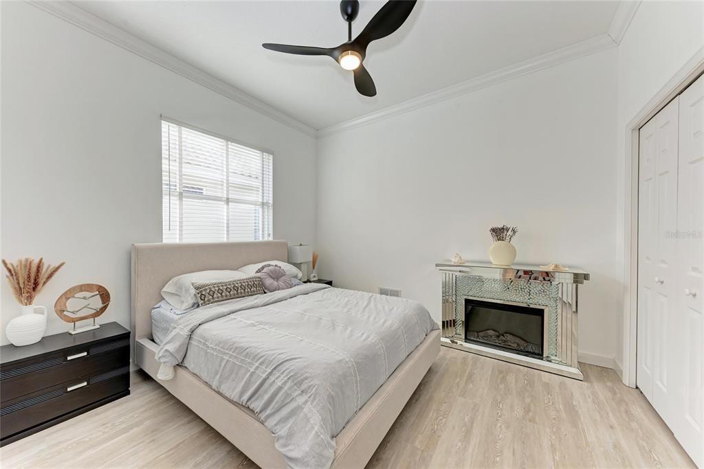 7128 Rue De Palisades, Unit 22 Sarasota, FL 34238 - Photo 27 of 41 a bedroom with a bed and a fireplace