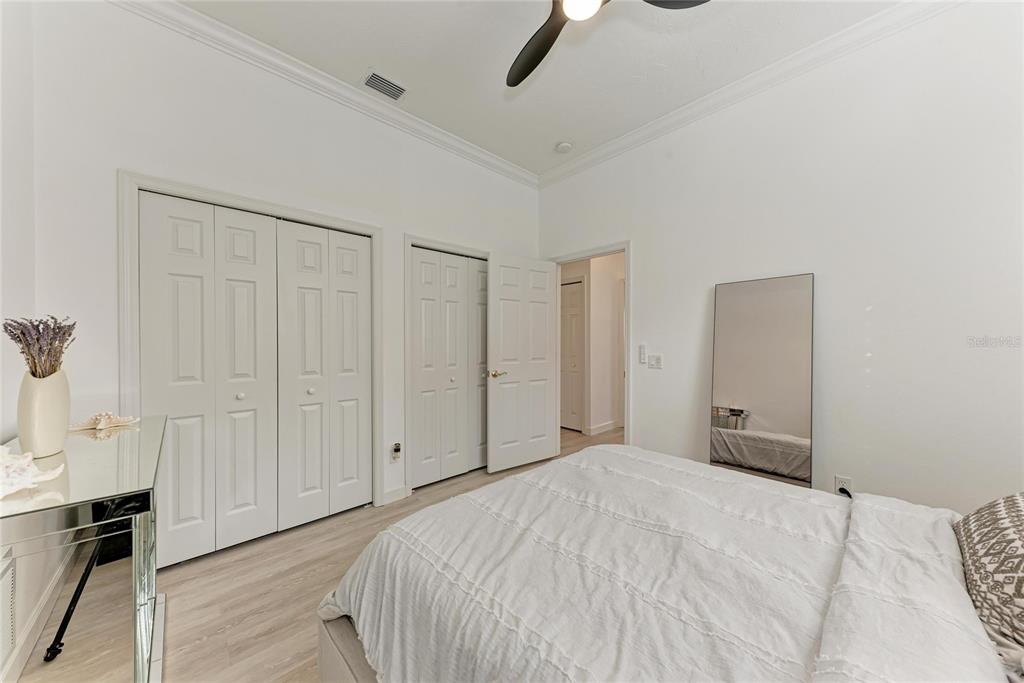 7128 Rue De Palisades, Unit 22 Sarasota, FL 34238 - Photo 29 of 41 a bedroom with a bed and a cabinet
