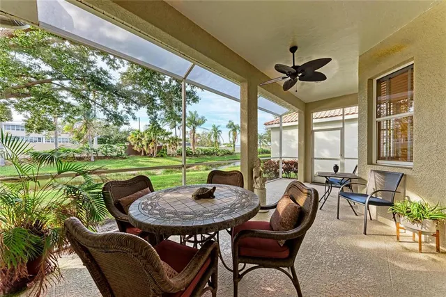 a view of a patio with a table chairs and a backyard