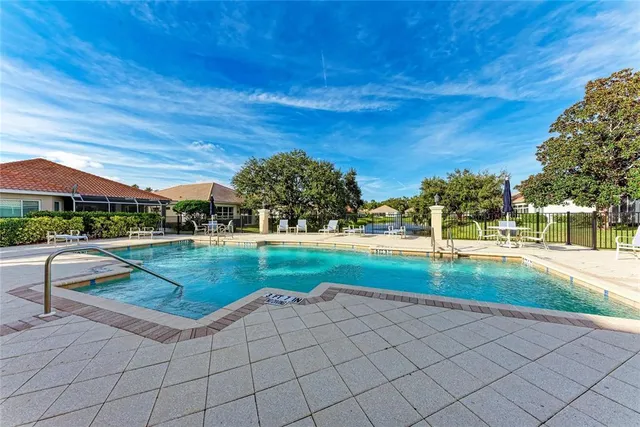 a view of yard with swimming pool and green space