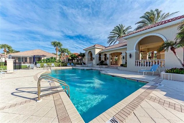 a swimming pool with outdoor seating and yard