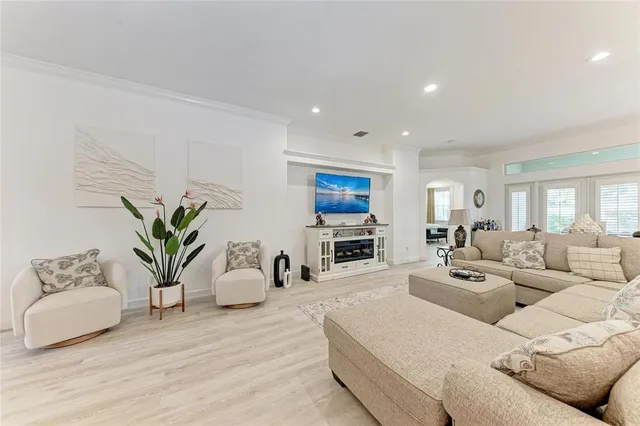 a living room with furniture a couch and a flat screen tv