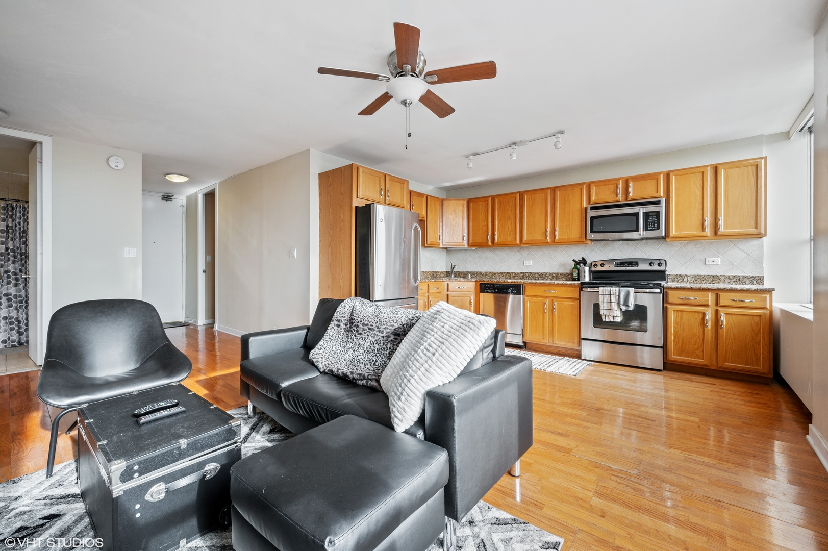 655 West Irving Park Road, Unit 4005 Chicago, IL 60613 - Photo 2 of 12 a living room with furniture and a wooden floor