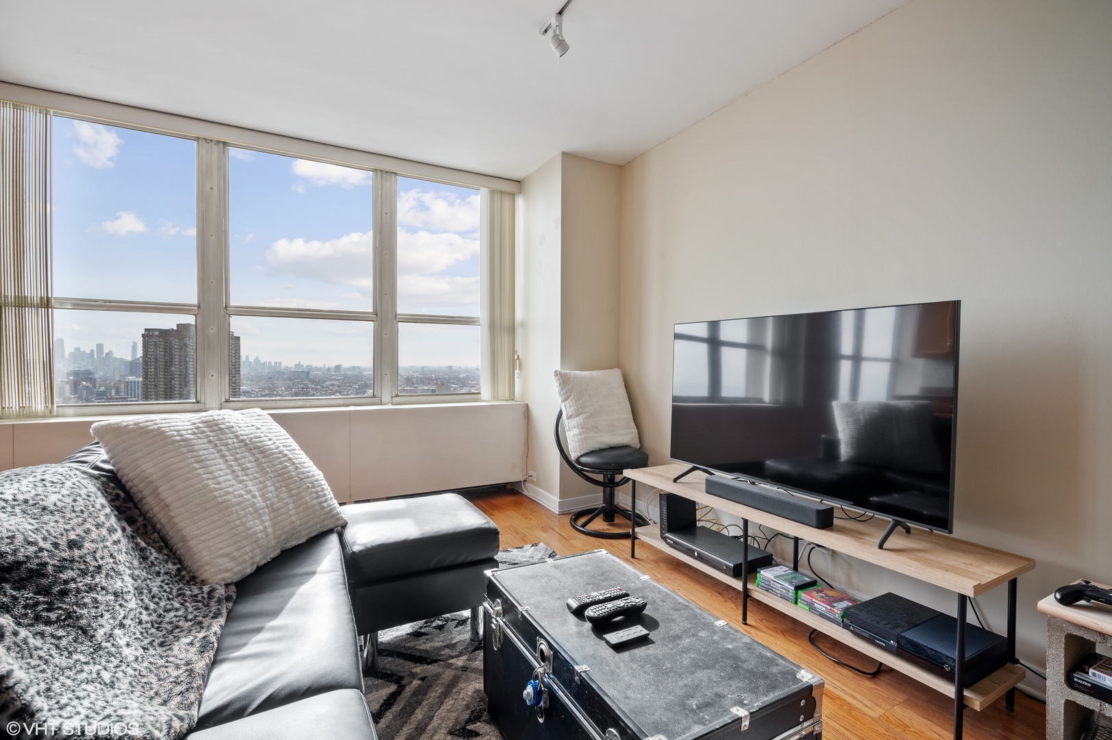 655 West Irving Park Road, Unit 4005 Chicago, IL 60613 - Photo 5 of 12 a living room with furniture and a flat screen tv