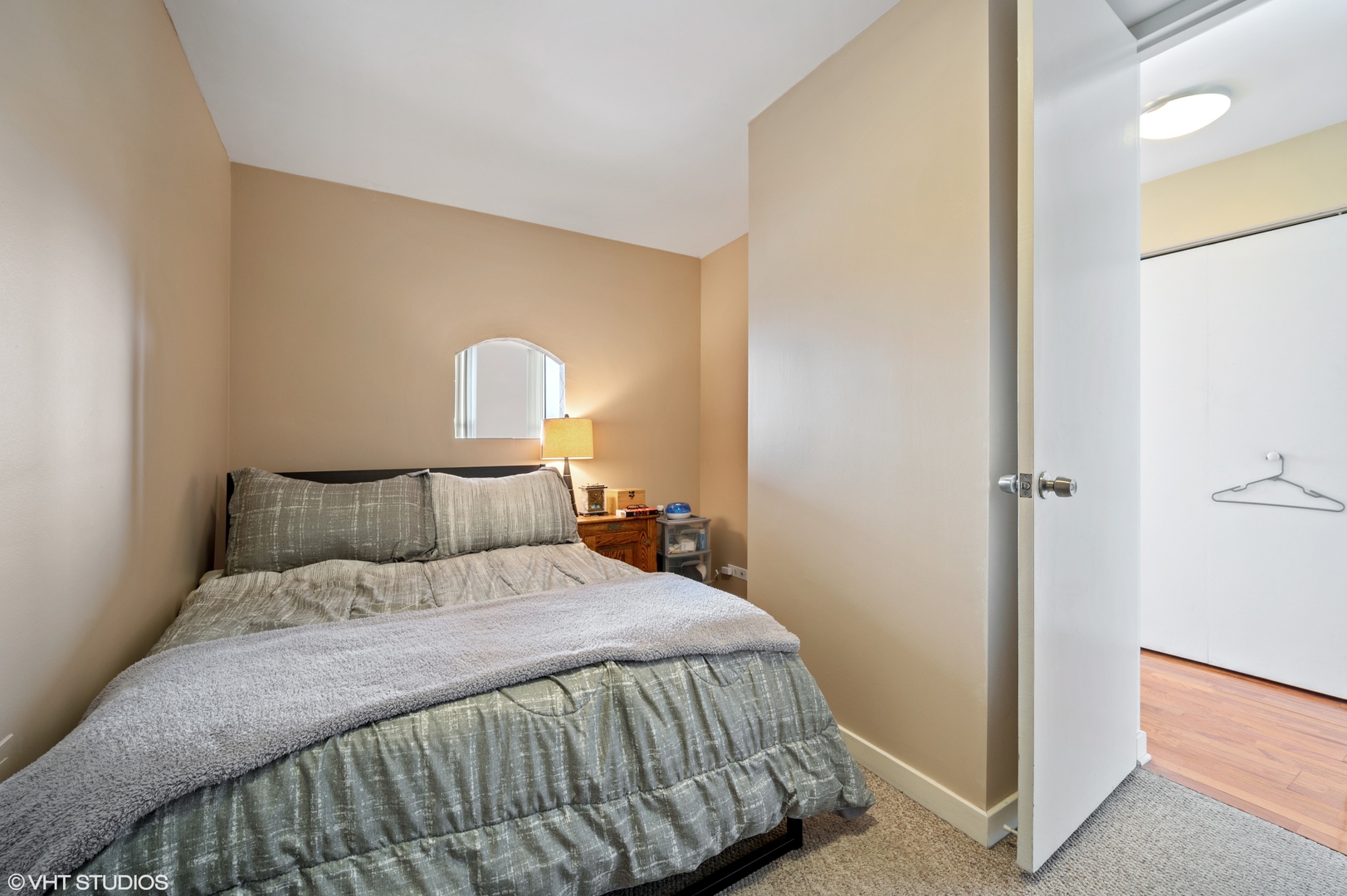 655 West Irving Park Road, Unit 4005 Chicago, IL 60613 - Photo 6 of 12 a bedroom with a bed and a mirror