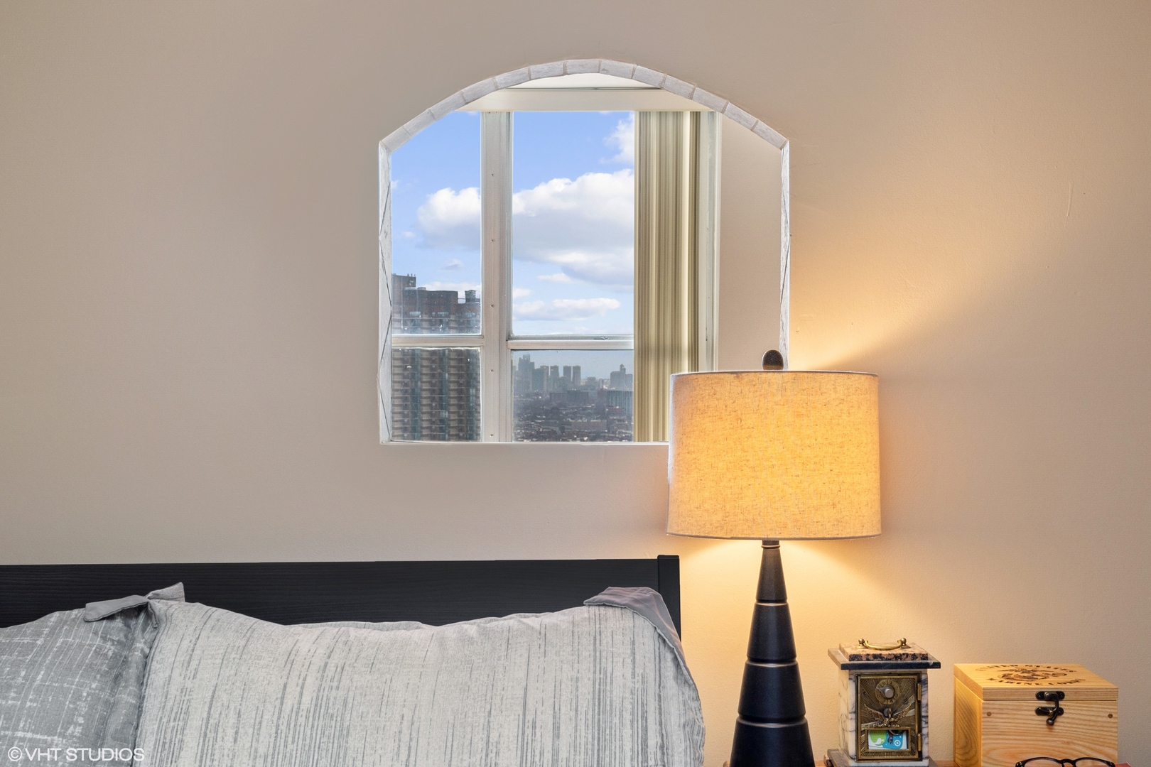 655 West Irving Park Road, Unit 4005 Chicago, IL 60613 - Photo 7 of 12 a bed with a black and white comforter and pillows