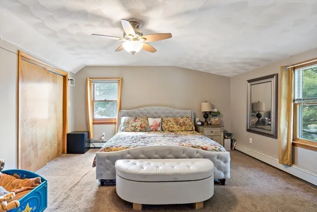 a bedroom with a bed and window