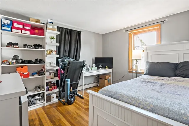 a bedroom with a bed and a desk in it