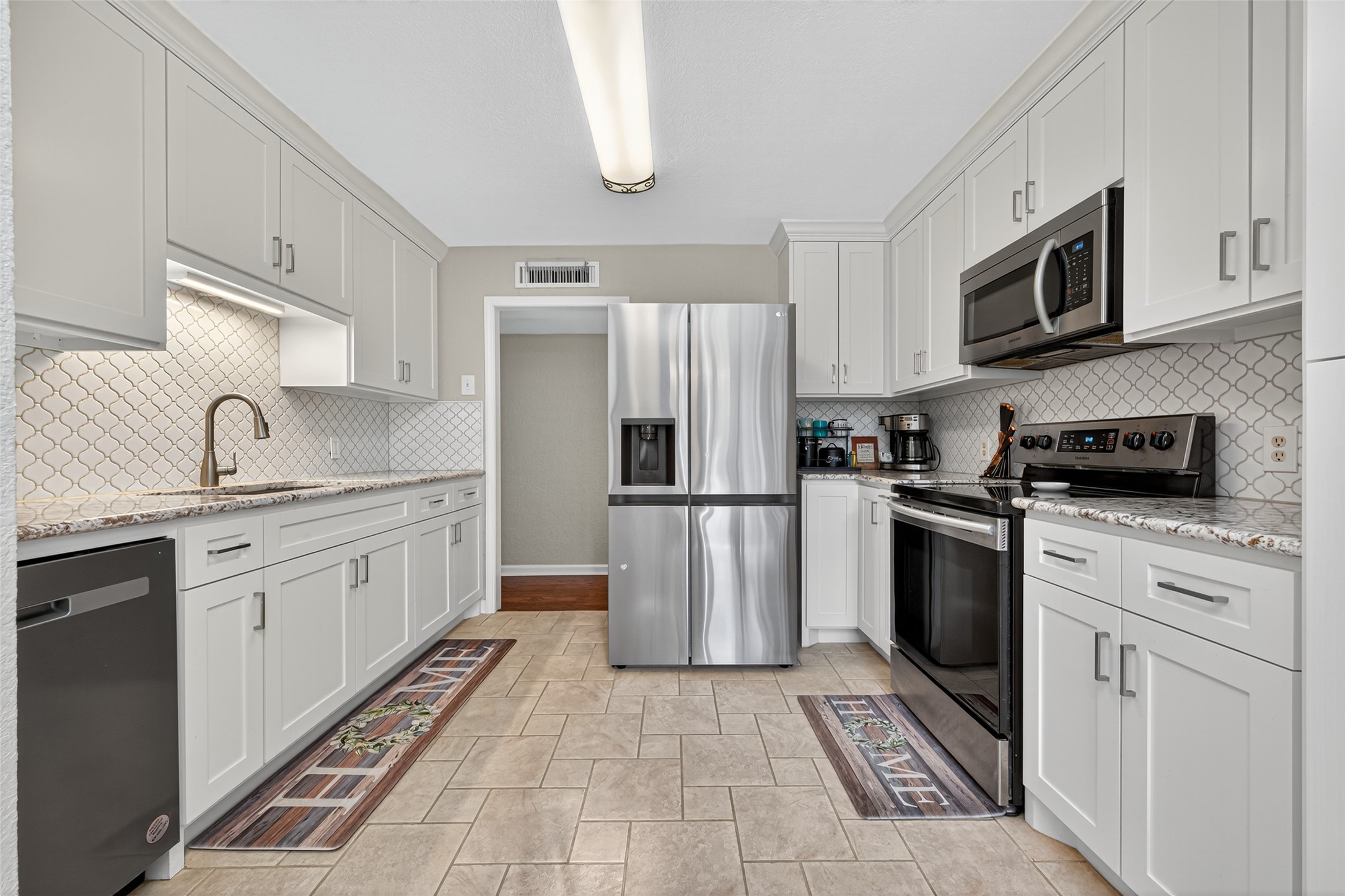 22815 Thadd's Trail Spring, TX 77373 - Photo 20 of 48 a kitchen with stainless steel appliances granite countertop a refrigerator sink and stove
