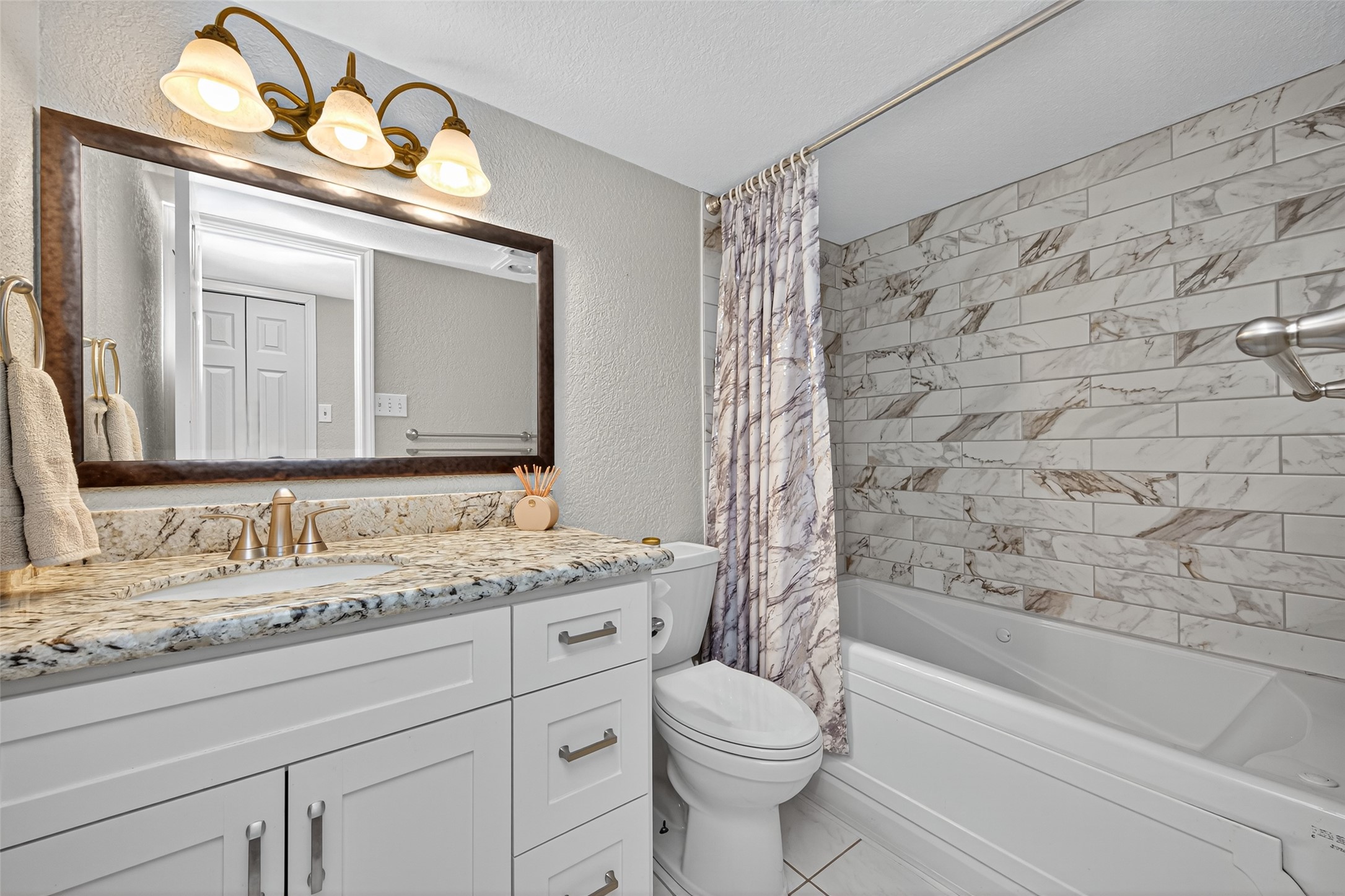 22815 Thadd's Trail Spring, TX 77373 - Photo 30 of 48 a bathroom with a granite countertop sink a toilet and a mirror