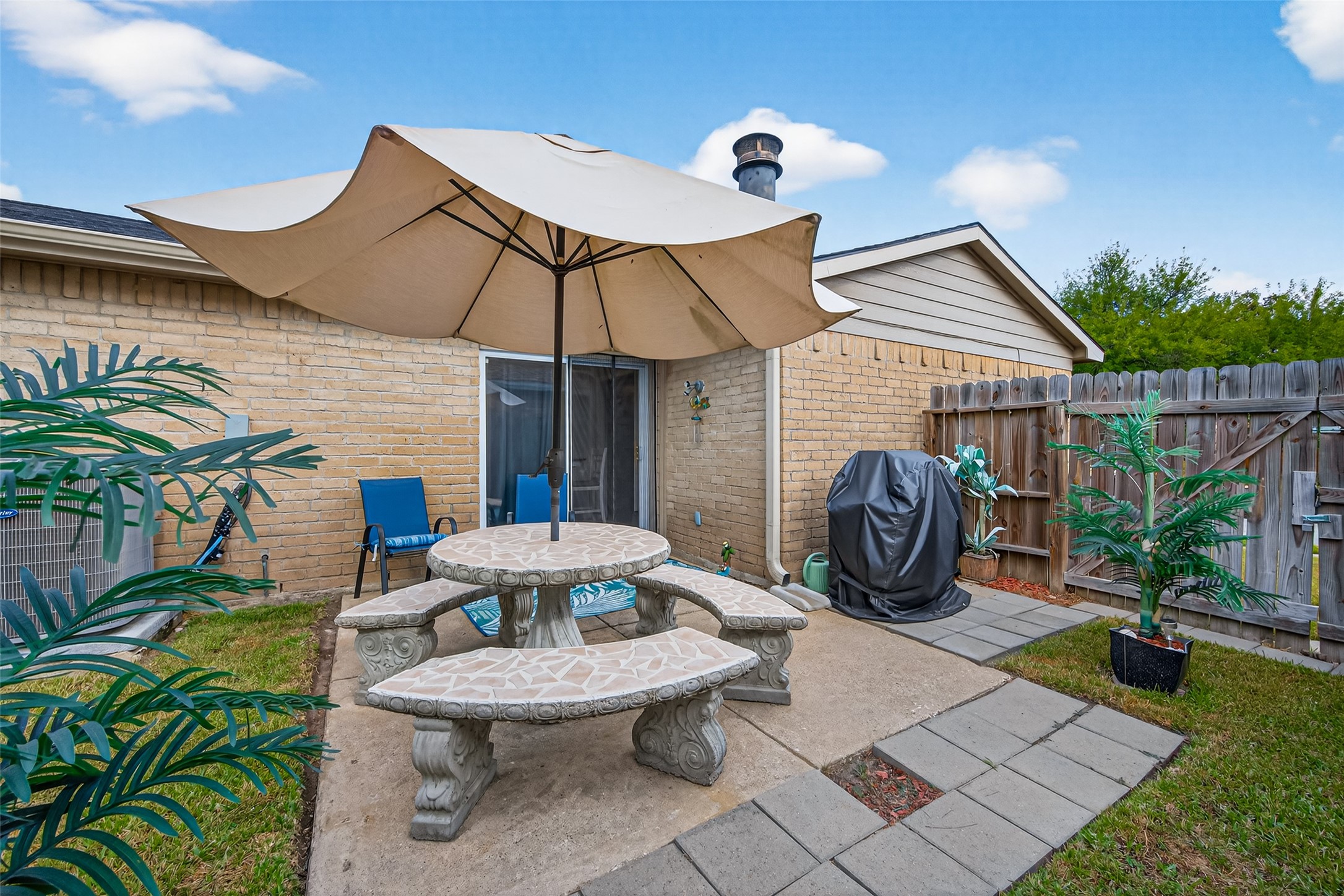 22815 Thadd's Trail Spring, TX 77373 - Photo 40 of 48 a view of a patio with table and chairs potted plants with wooden fence