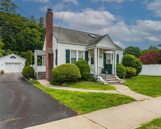 a view of a house with a backyard and porch