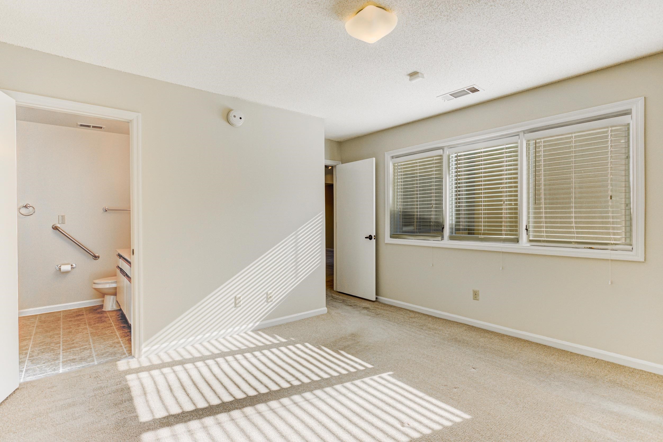 5013 Scheibler Road, Unit C1 Memphis, TN 38128 - Photo 11 of 36 Empty room featuring a textured ceiling and light carpet