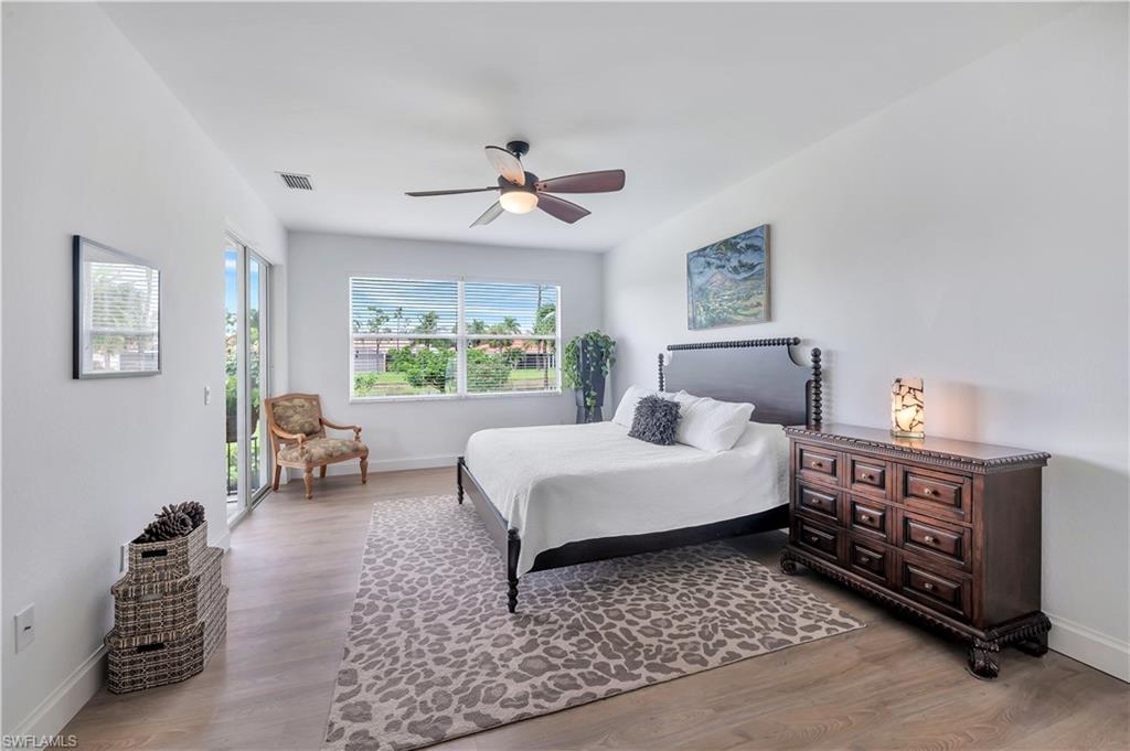 14095 Mirror Court Naples, FL 34114 - Photo 16 of 45 Bedroom with access to exterior, light wood-style floors, and a ceiling fan