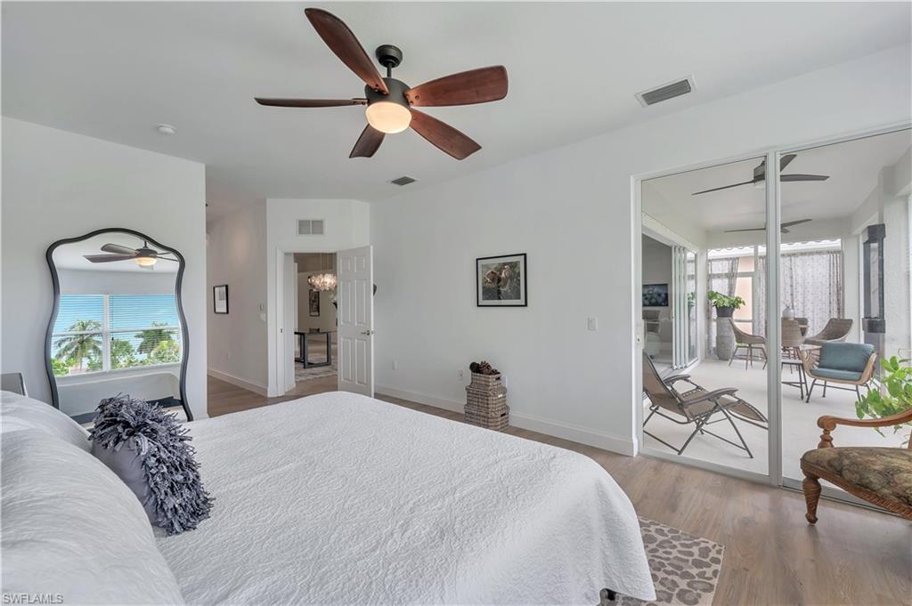 14095 Mirror Court Naples, FL 34114 - Photo 17 of 45 Bedroom with wood finished floors, ceiling fan, and access to exterior